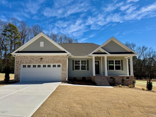 craftsman inspired home with a porch, brick siding, driveway, and an attached garage