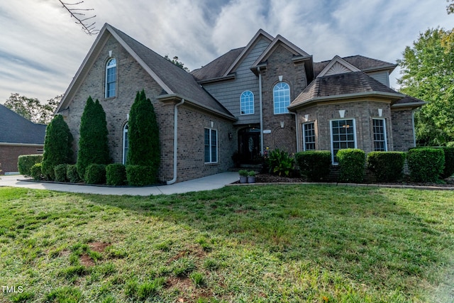 view of front facade with a patio and a front yard