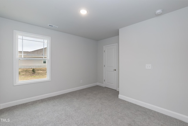 unfurnished room with light colored carpet