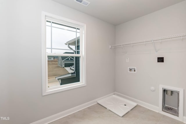 laundry area with hookup for a gas dryer, light tile patterned floors, washer hookup, and electric dryer hookup