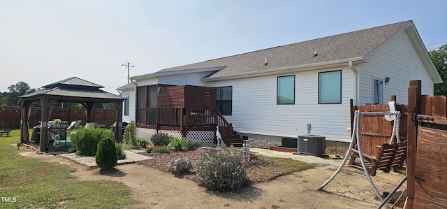 back of house featuring central AC, a wooden deck, and a gazebo