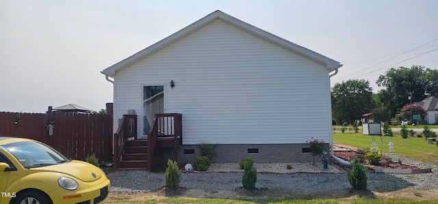 view of side of home with a lawn