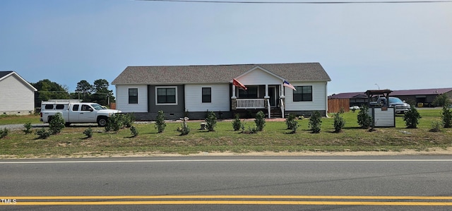 view of front of house with a porch and a front lawn