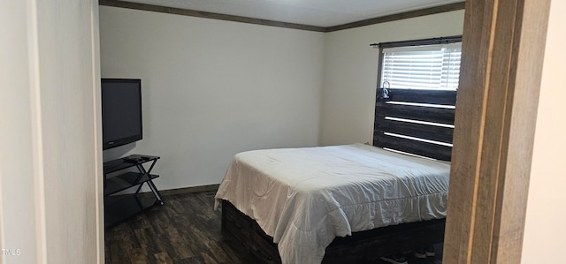 bedroom with dark wood-type flooring and ornamental molding