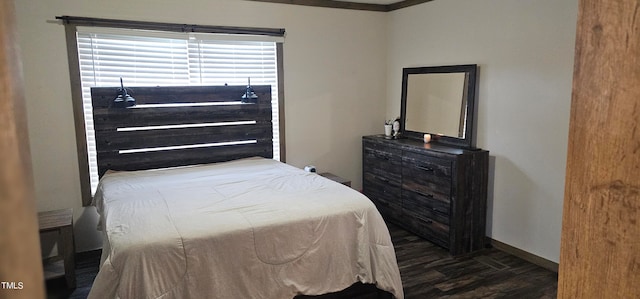 bedroom with crown molding and dark wood-type flooring