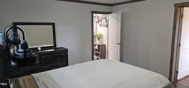 bedroom featuring ornamental molding and wood-type flooring