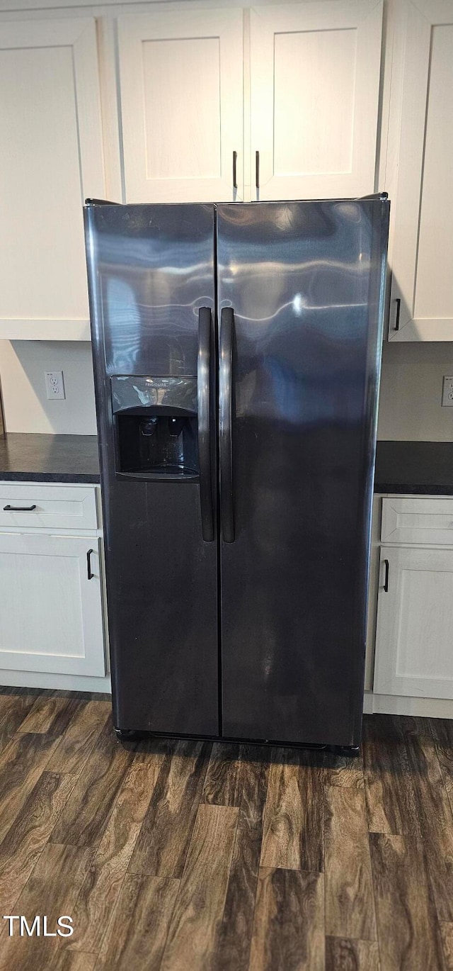 room details with white cabinetry, dark hardwood / wood-style flooring, and refrigerator with ice dispenser