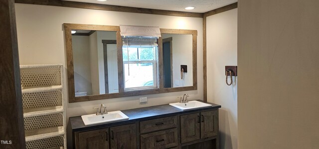 bathroom with a textured ceiling and vanity