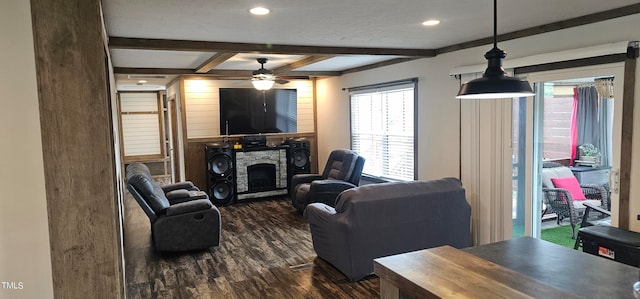 living room with a fireplace, a textured ceiling, ceiling fan, dark wood-type flooring, and beam ceiling