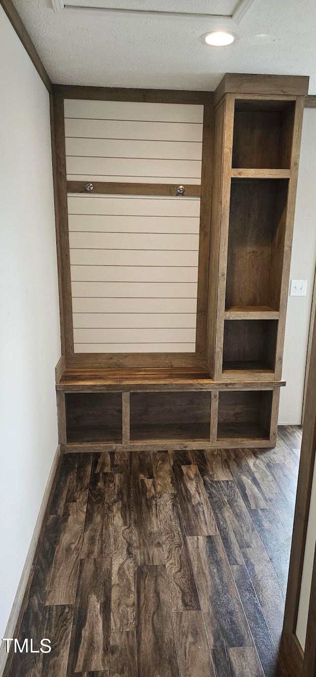 mudroom with a textured ceiling and dark hardwood / wood-style floors