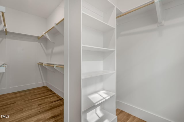 walk in closet with hardwood / wood-style floors