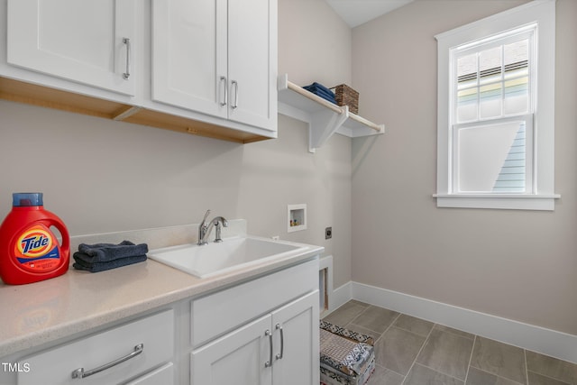 clothes washing area with hookup for a washing machine, cabinets, sink, and hookup for an electric dryer