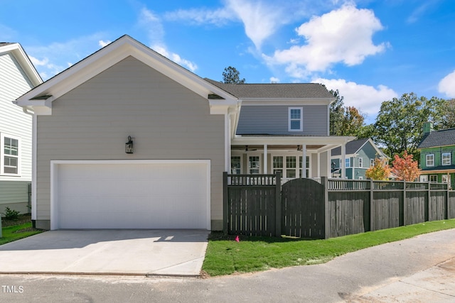 front of property with ceiling fan and a garage