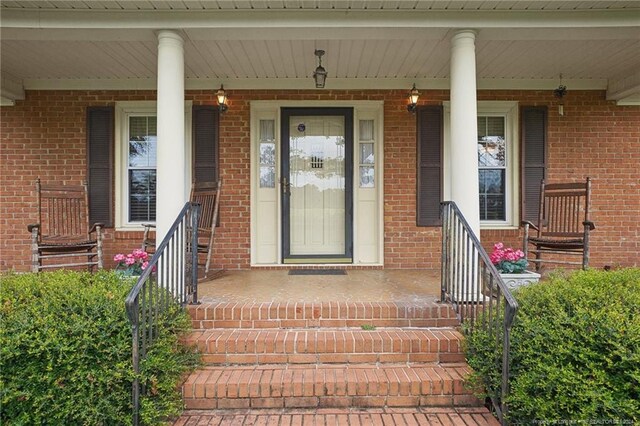 view of exterior entry with covered porch