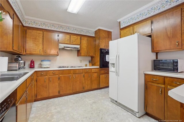 kitchen with ornamental molding, white appliances, sink, and a textured ceiling