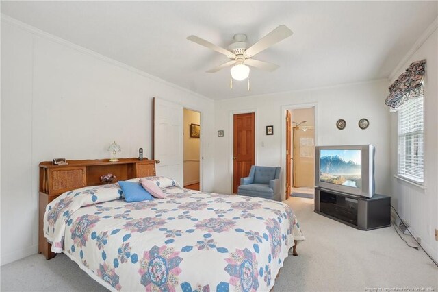 bedroom with crown molding, ceiling fan, and light carpet