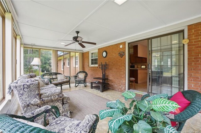 sunroom / solarium featuring ceiling fan