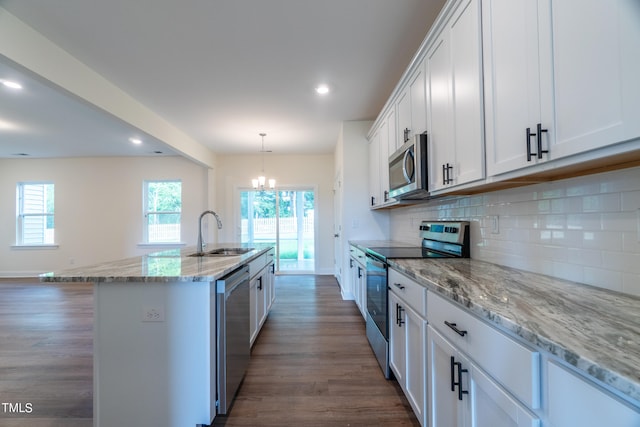 kitchen with a kitchen island with sink, appliances with stainless steel finishes, white cabinetry, and sink