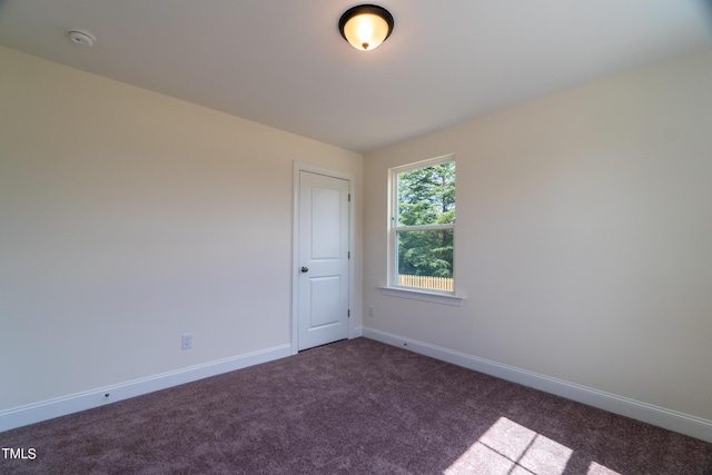 empty room with carpet and baseboards