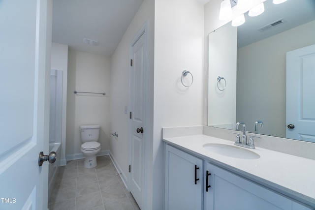 bathroom with vanity, toilet, a bathing tub, and tile patterned flooring