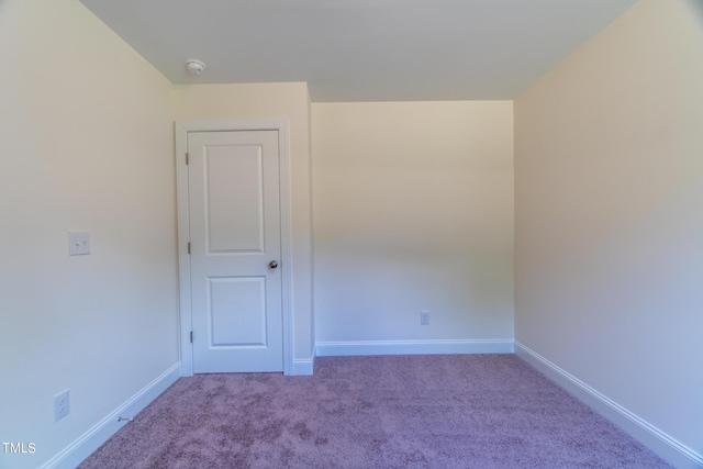 empty room with baseboards and carpet floors