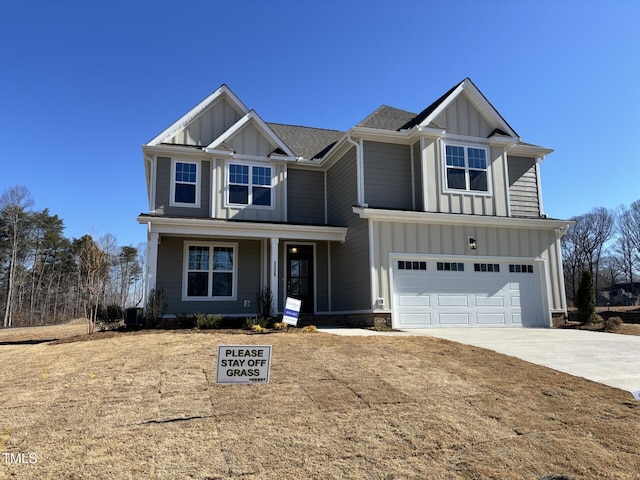 view of front of property with an attached garage, covered porch, board and batten siding, and driveway