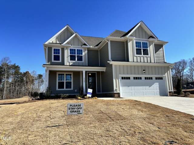 view of front of house featuring board and batten siding, concrete driveway, and a garage