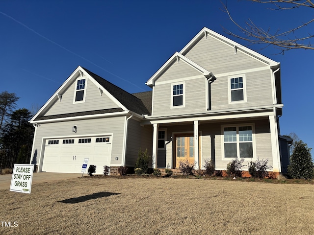 view of front of property with a porch, a garage, and driveway