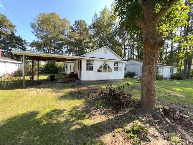 view of front of house with a front yard and a carport