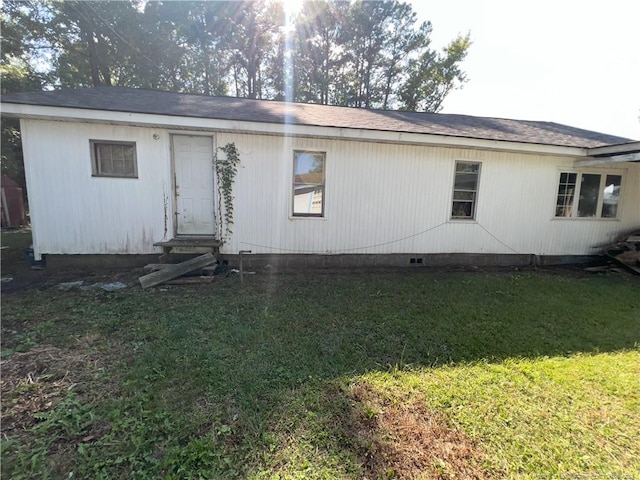 back of house with a lawn