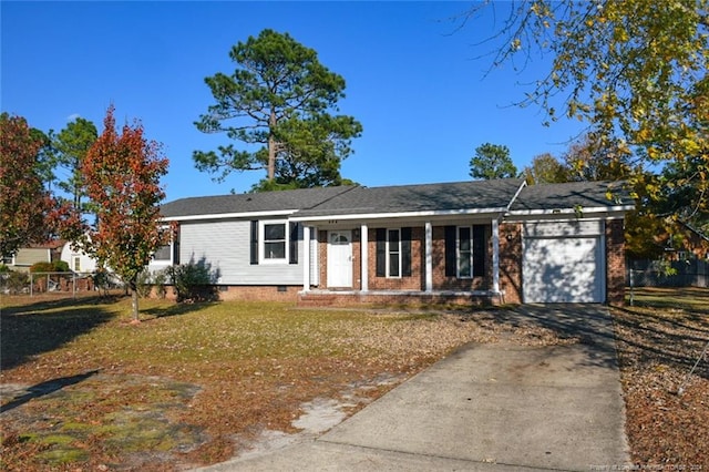 single story home featuring a front lawn and a garage