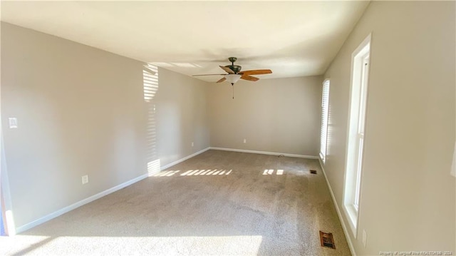 carpeted empty room with ceiling fan