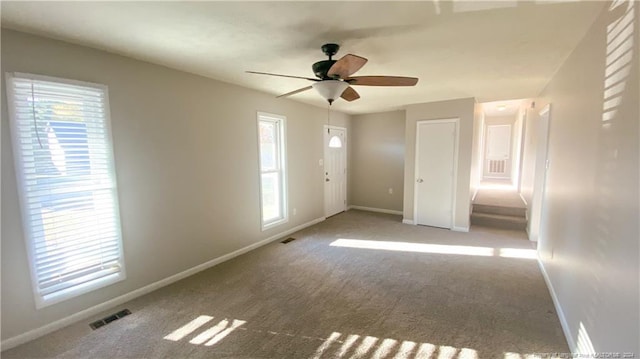 unfurnished bedroom with ceiling fan and carpet