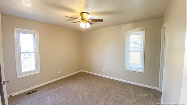 spare room with carpet floors and ceiling fan