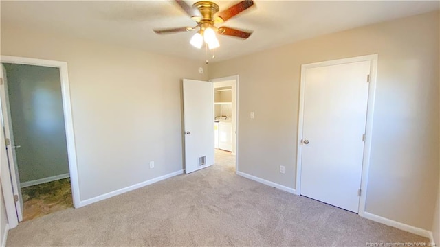 unfurnished bedroom with a closet, light colored carpet, and ceiling fan