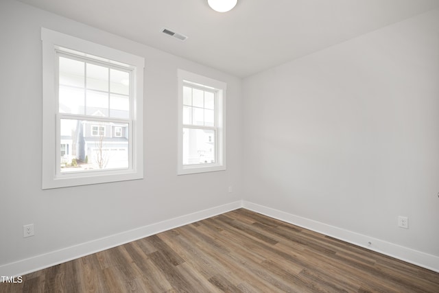 spare room with dark hardwood / wood-style flooring