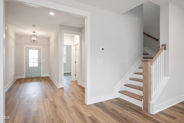 foyer entrance featuring a chandelier and light wood-type flooring