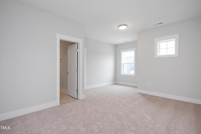 empty room featuring light carpet