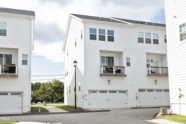 view of front of house featuring a balcony and a garage