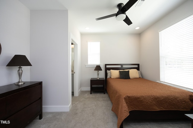 carpeted bedroom with ceiling fan and multiple windows