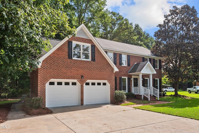 view of front of house with a front yard and a garage