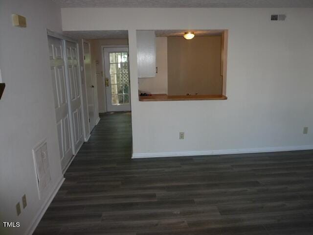 8220 Mcguire Dr, Raleigh, NC 27616 - interior space with dark wood-style flooring, baseboards, and visible vents