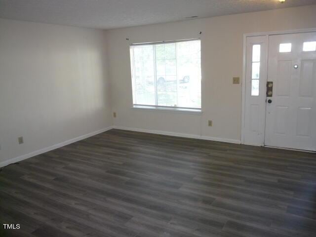 8220 Mcguire Dr, Raleigh, NC 27616 - foyer with baseboards and dark wood-style floors