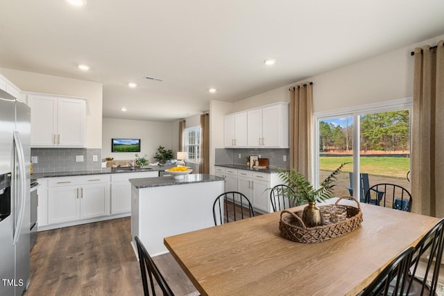 kitchen featuring tasteful backsplash, a center island, white cabinets, and dark hardwood / wood-style floors