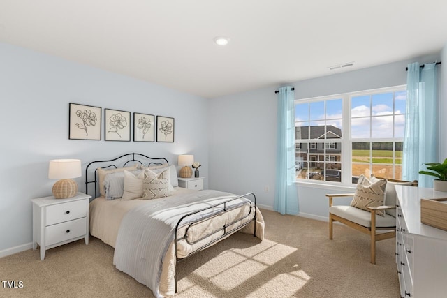 bedroom featuring light colored carpet