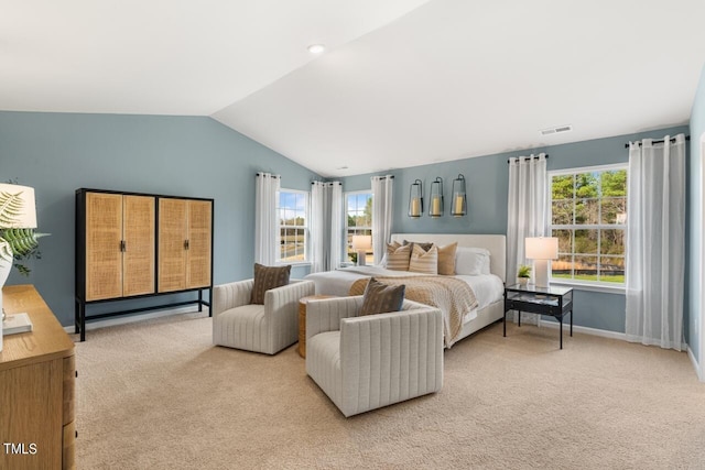 bedroom featuring multiple windows, light carpet, and vaulted ceiling