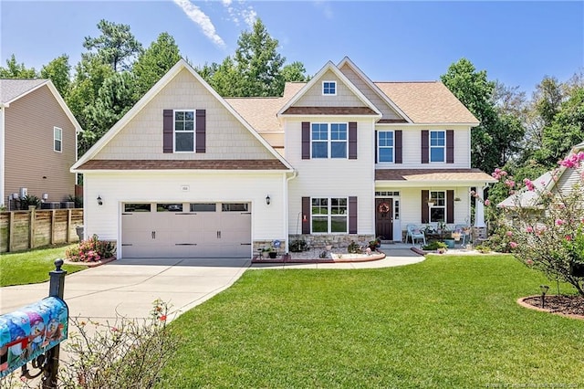 craftsman house with a front yard and a garage