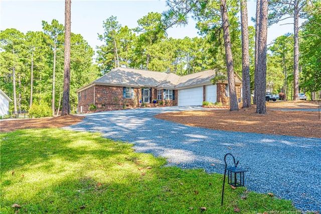 single story home with a garage, crawl space, gravel driveway, a front yard, and brick siding