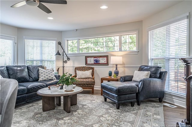 living room featuring ceiling fan, visible vents, wood finished floors, and recessed lighting