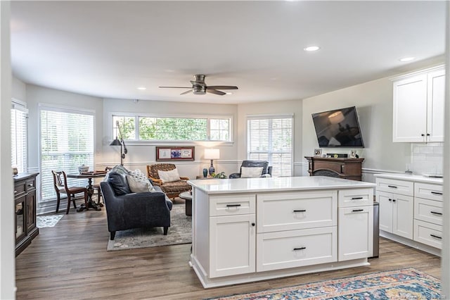 kitchen featuring white cabinets, light countertops, and open floor plan